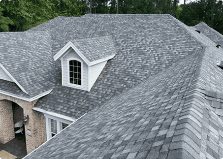 Gray architectural asphalt shingle roof with a dormer window