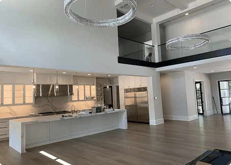Renovated open-concept kitchen and living area with white cabinetry